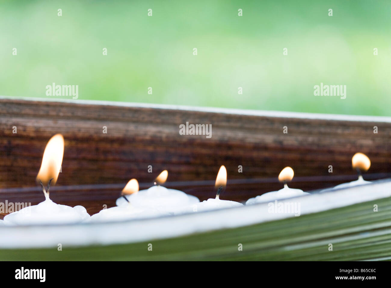 Lit votive candles in natural setting Stock Photo Alamy