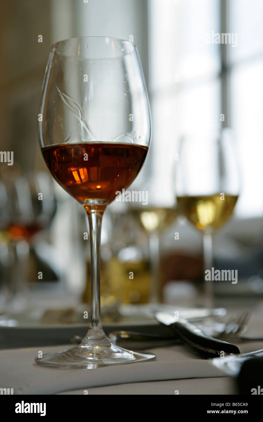 Glass of sherry, other glasses of wine in background Stock Photo