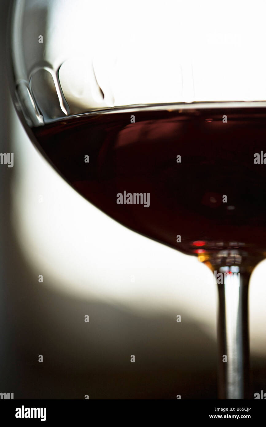 Red wine, bowl of wineglass displaying tears of wine, closeup Stock