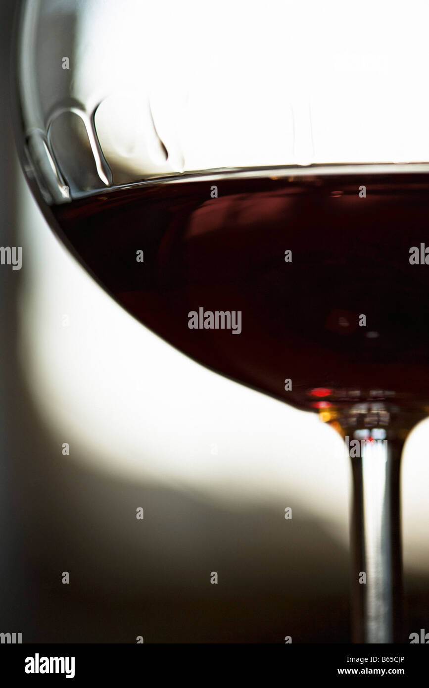Red wine, bowl of wineglass displaying tears of wine, close-up Stock Photo