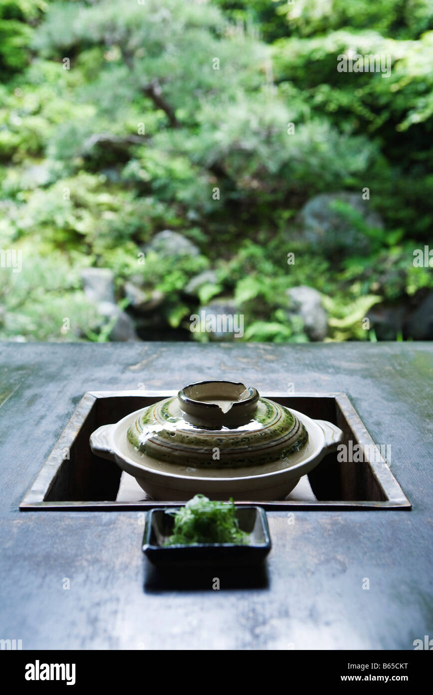 Japanese brazier, with dish of green soy noodles Stock Photo