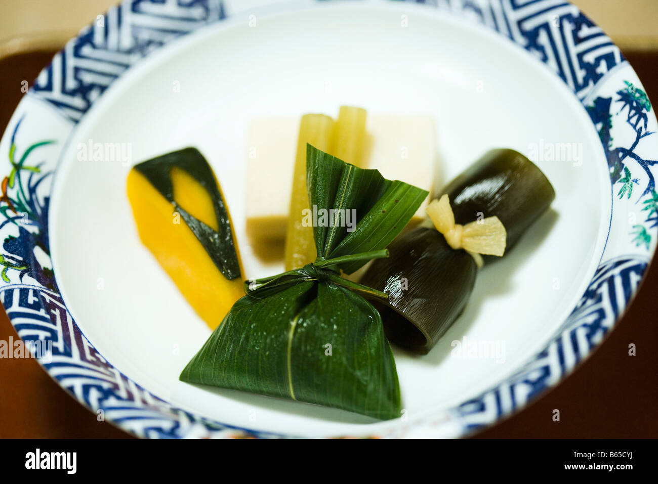 Assortment of Japanese foods on plate, winter squash, tofu, pickled