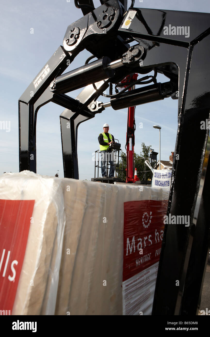 Construction Worker operating Crane and Fork Lift Stock Photo Alamy