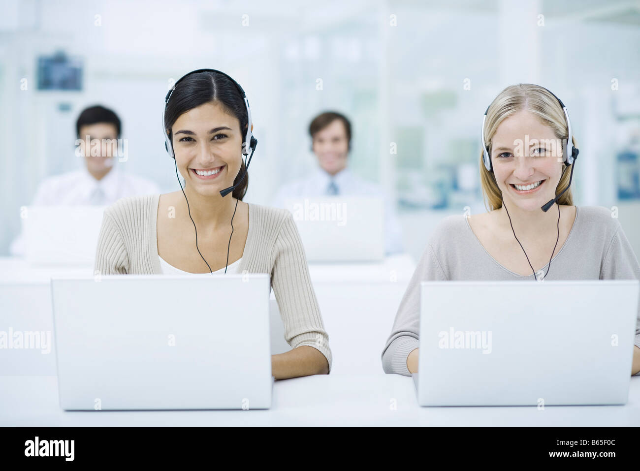 Telemarketers working in call center smiling Stock Photo Alamy