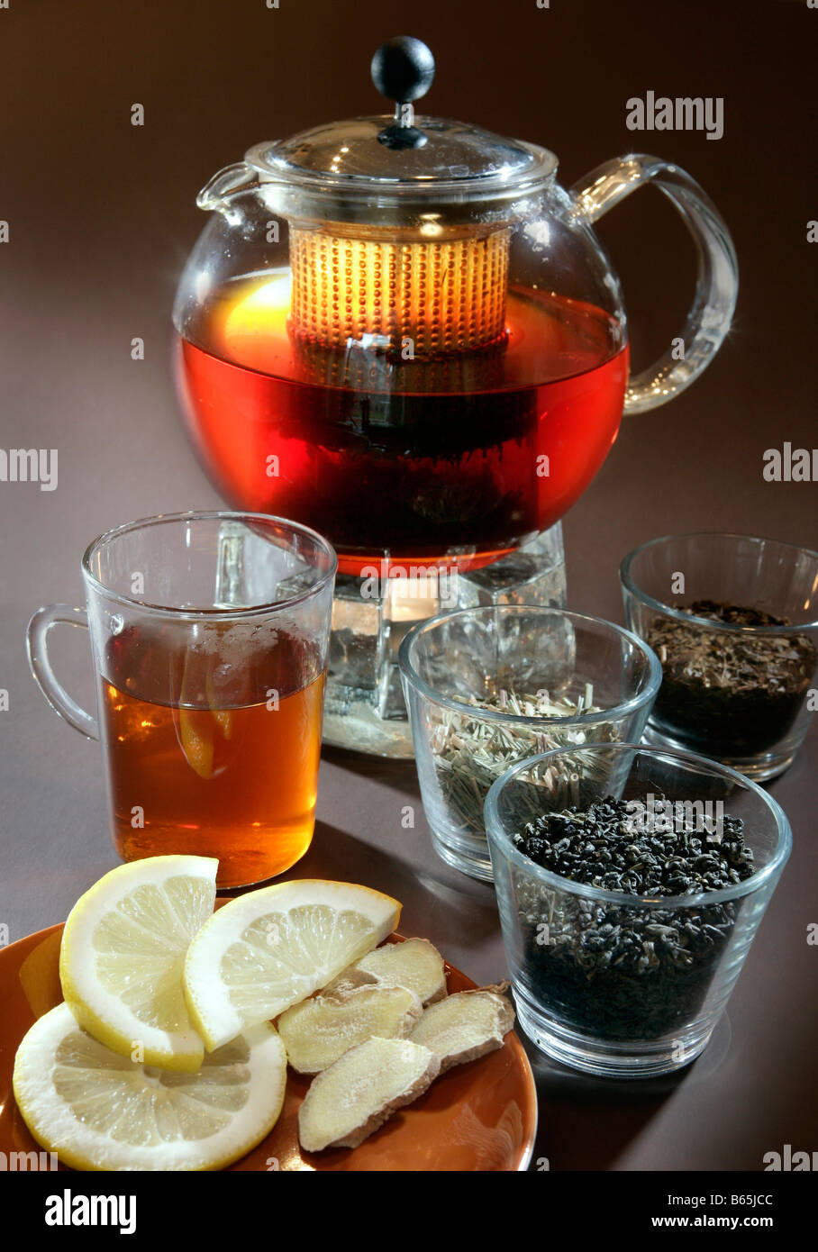 Tea still life with rooibos tea & teacup, teapot, lemon and ginger Stock Photo