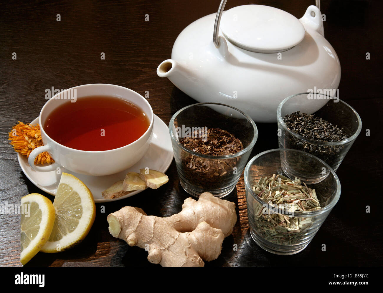 Tea still life with rooibos tea & teacup, teapot, lemon and ginger Stock Photo