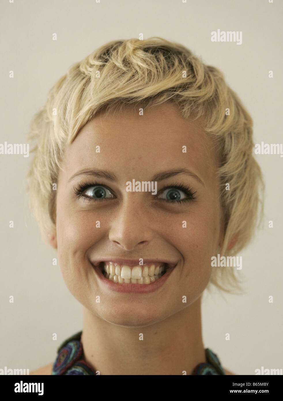 Portrait of a young blonde woman with a toothy smile Stock Photo