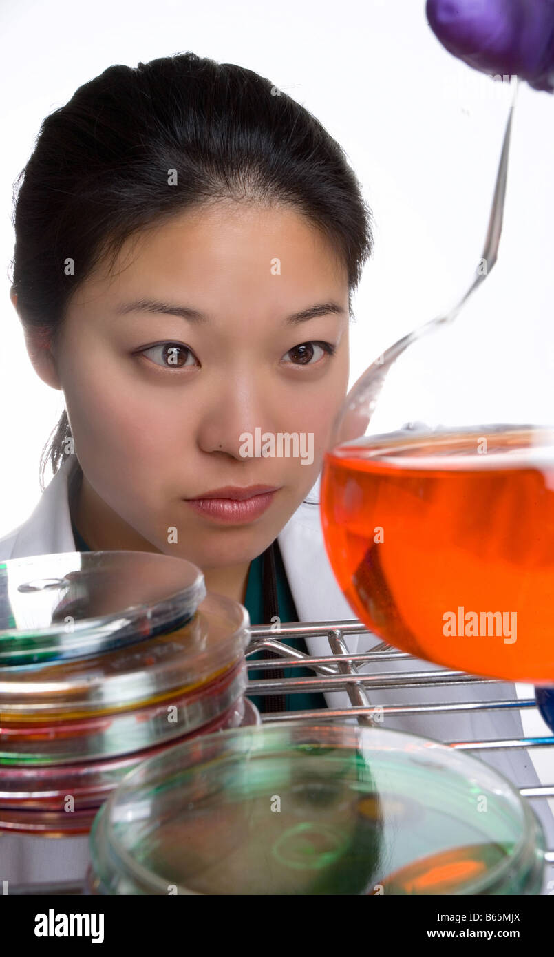 Female researcher working with solutions in lab. Stock Photo