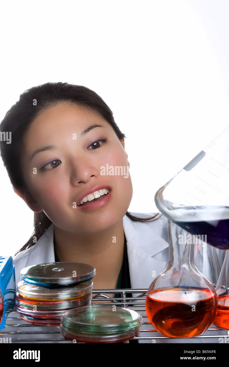 Woman mixing solutions in lab Stock Photo Alamy