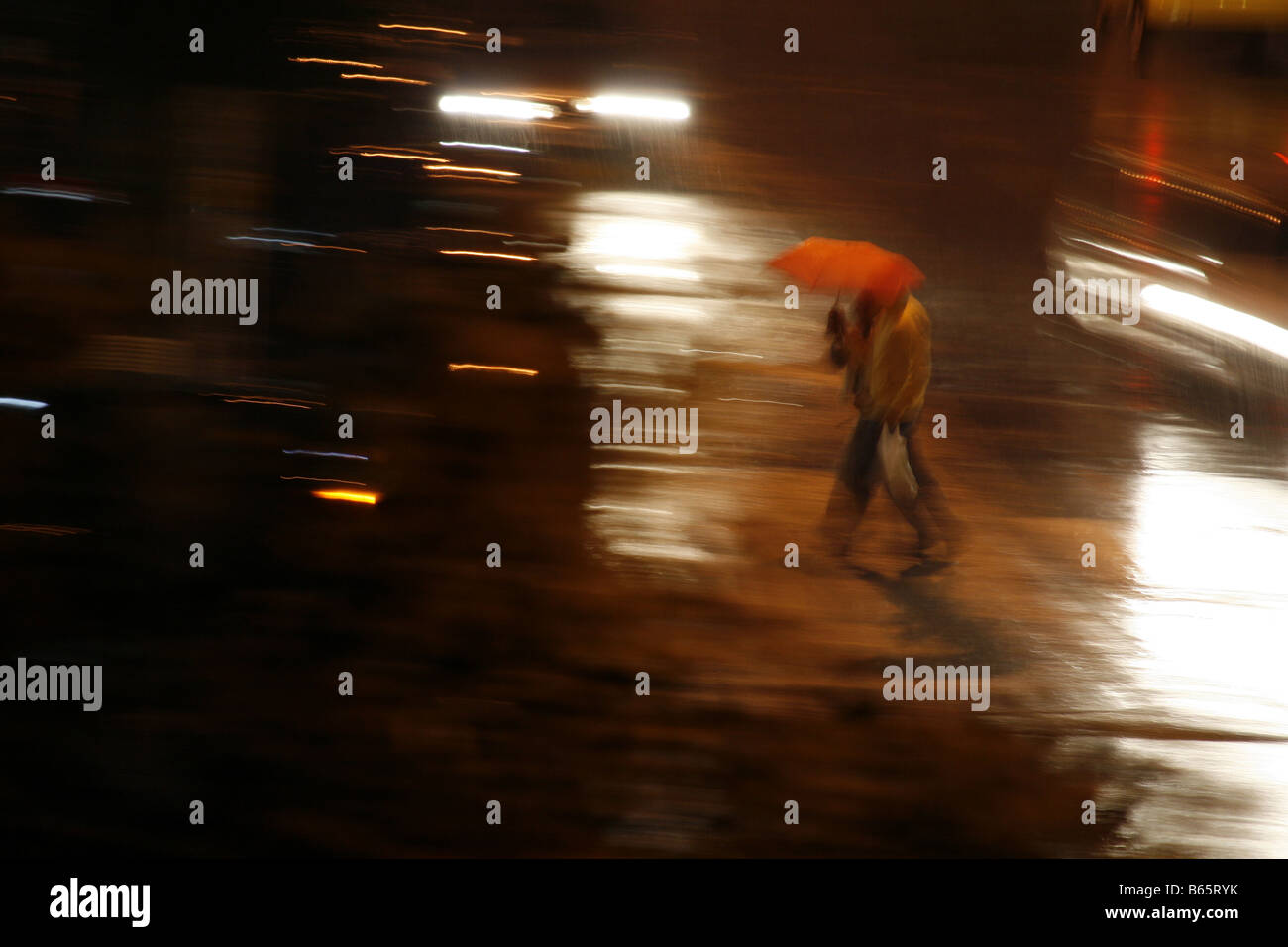 people sharing umbrella heavy rain at night in town Stock Photo Alamy
