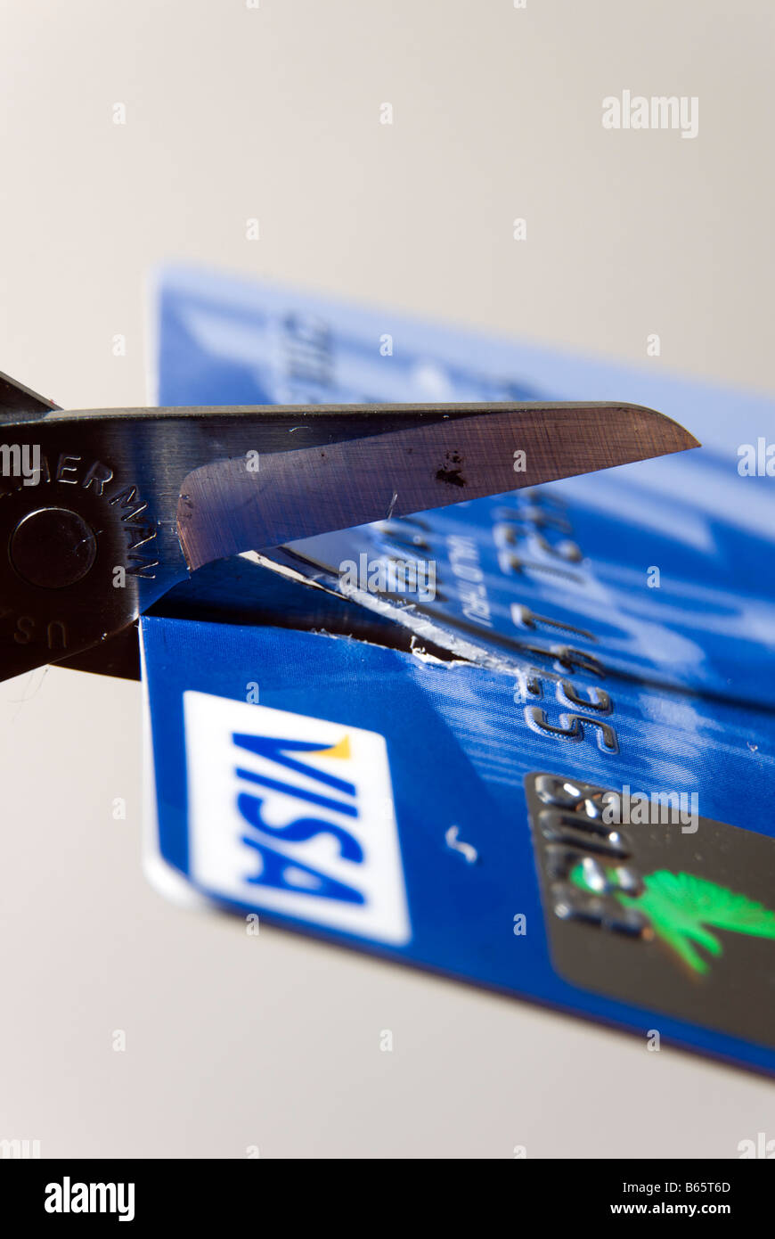 Scissors cutting up bank credit card Stock Photo