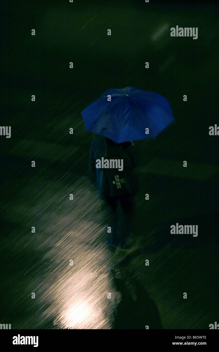 person with umbrella heavy rain at night in town Stock Photo Alamy