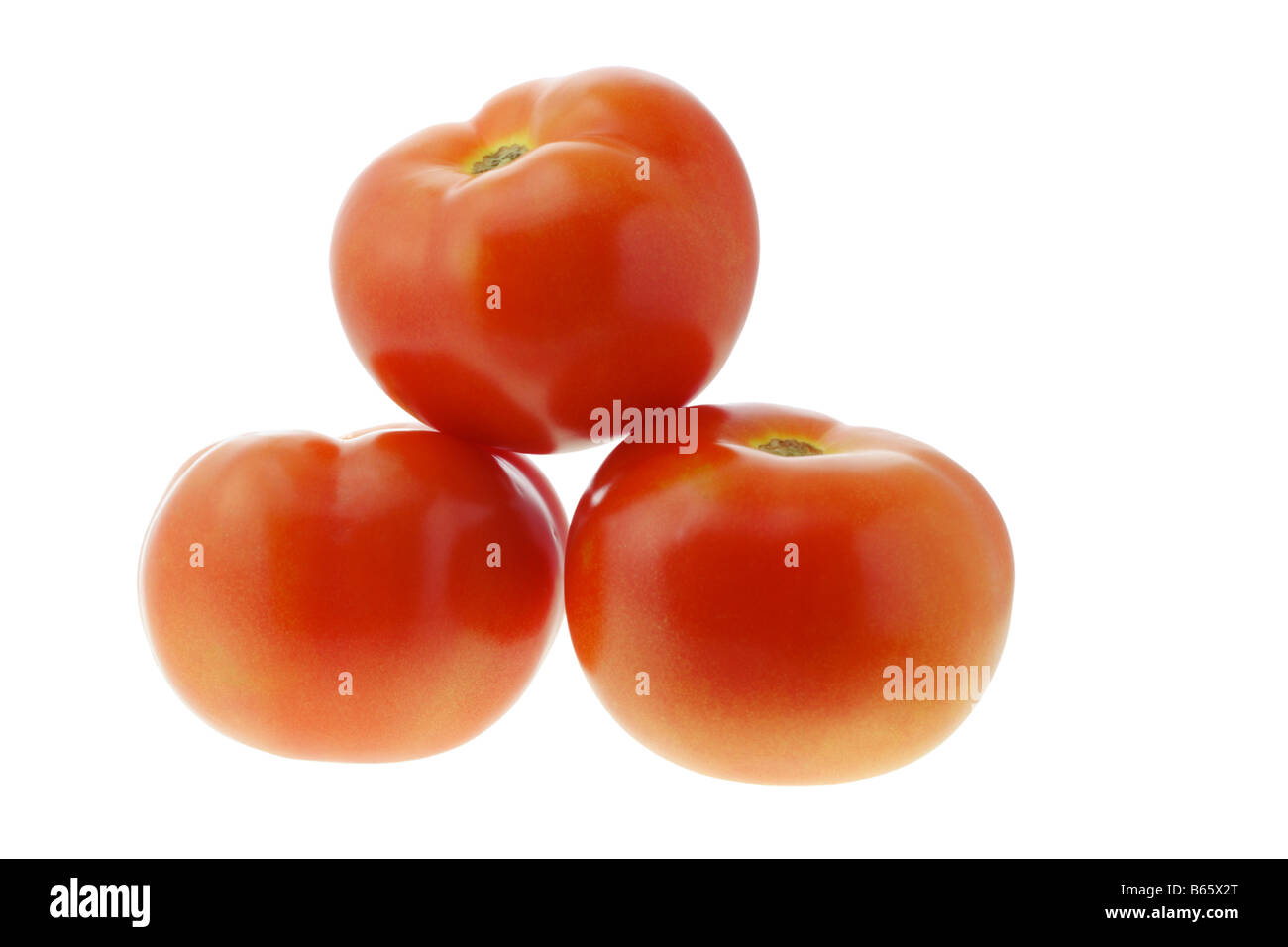 Three fresh tomatoes isolated on white background Stock Photo