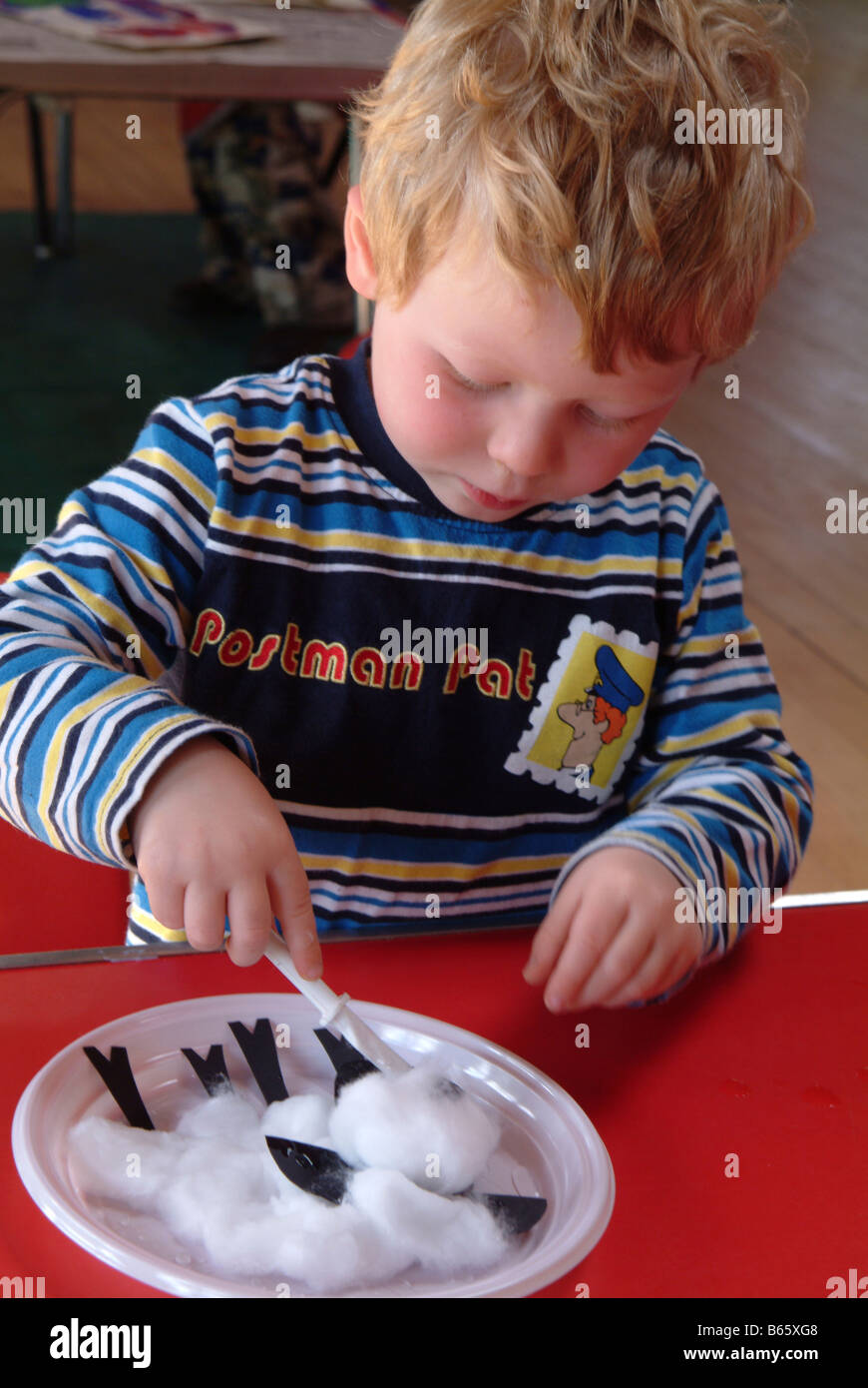 Little boy making a picture out of cotton wool Stock Photo Alamy