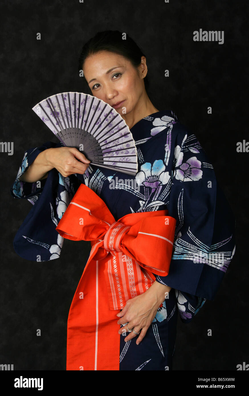Japanese Woman in a Blue Kimono with a Fan Stock Photo