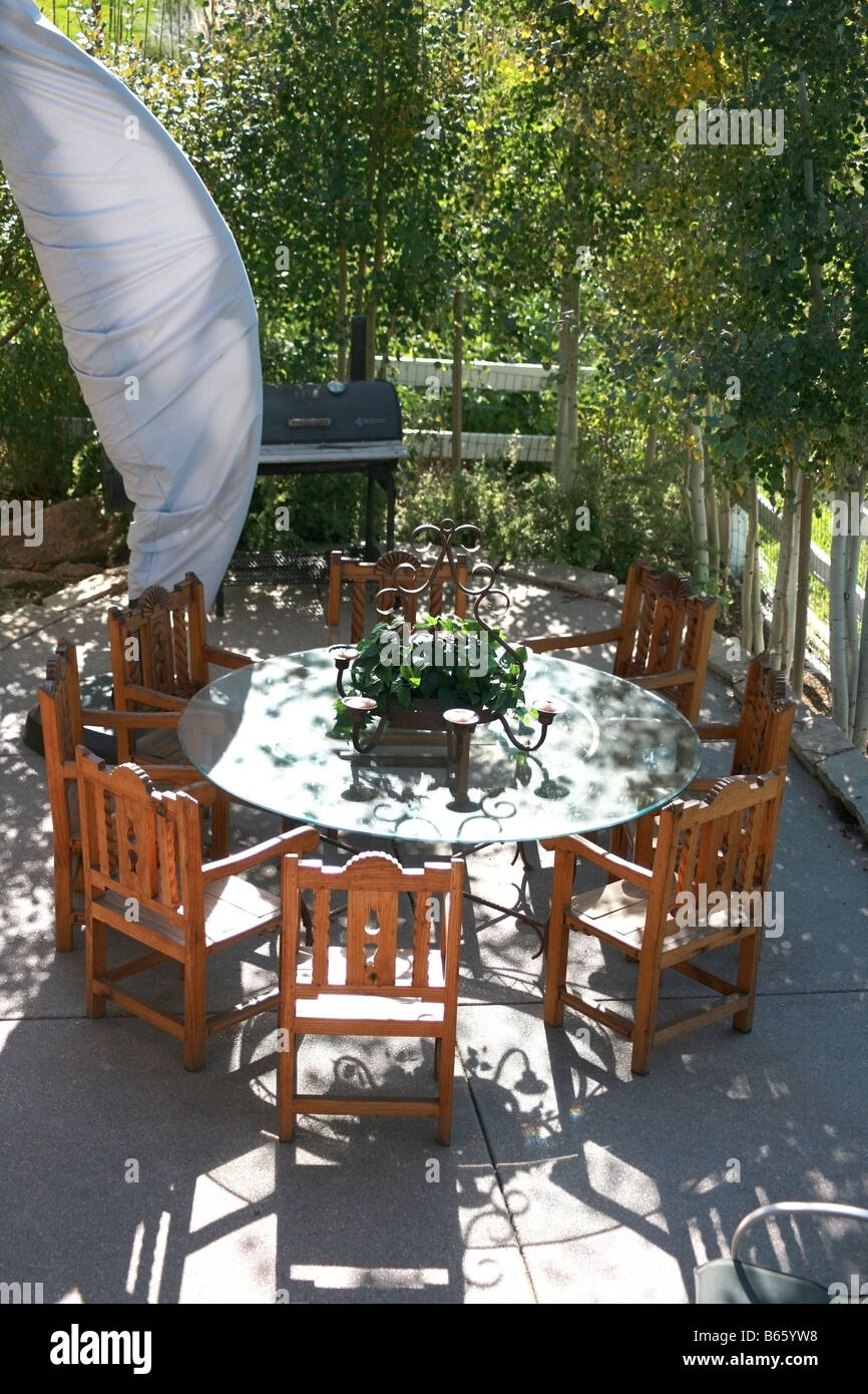 A table and chairs on a backyard patio Stock Photo