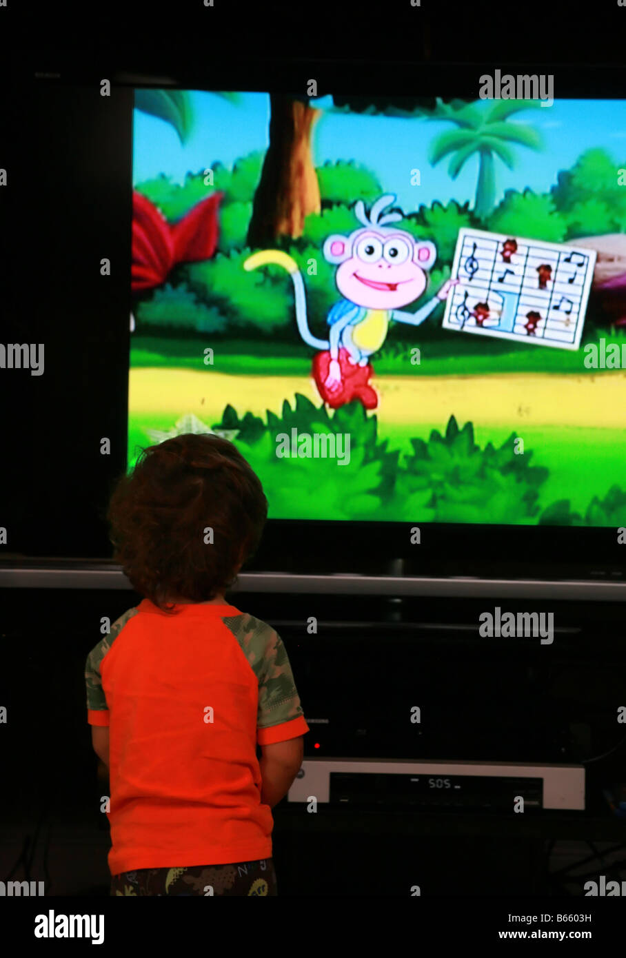 A young child watching cartoons on tv Stock Photo 21030117 Alamy