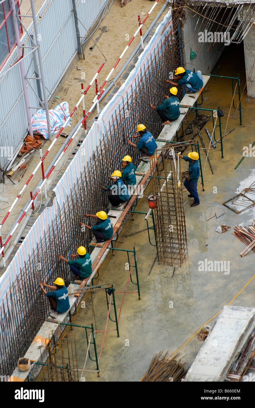 Genshed Inconstruction Vietnamese construction workers assembling steel mesh reinforements ...