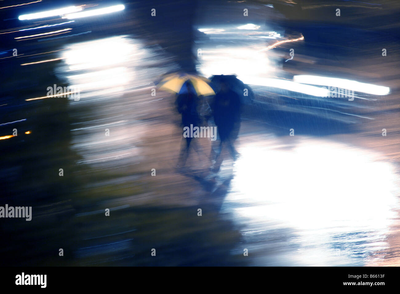 people walking in heavy rain at night in town Stock Photo - Alamy