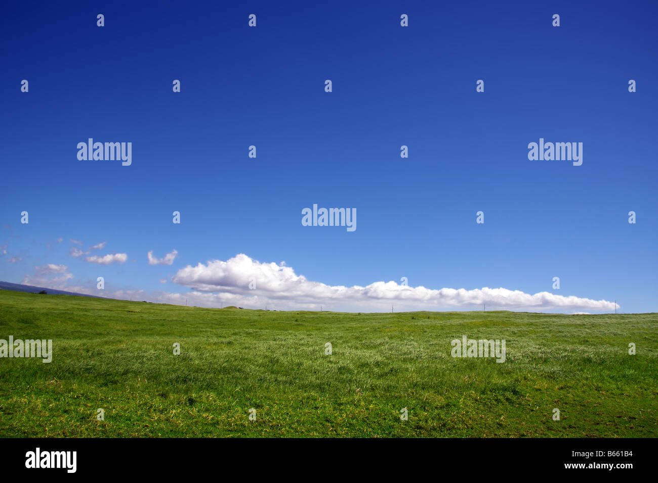 Background of cloudy sky and grass hill Stock Photo - Alamy