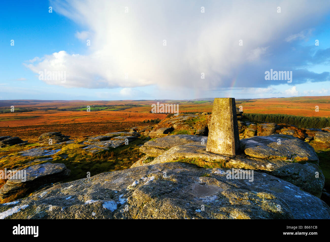 Early morning light at Bellever Tor on Dartmoor in South Devon UK with the triangulation pillar on the summit Stock Photo