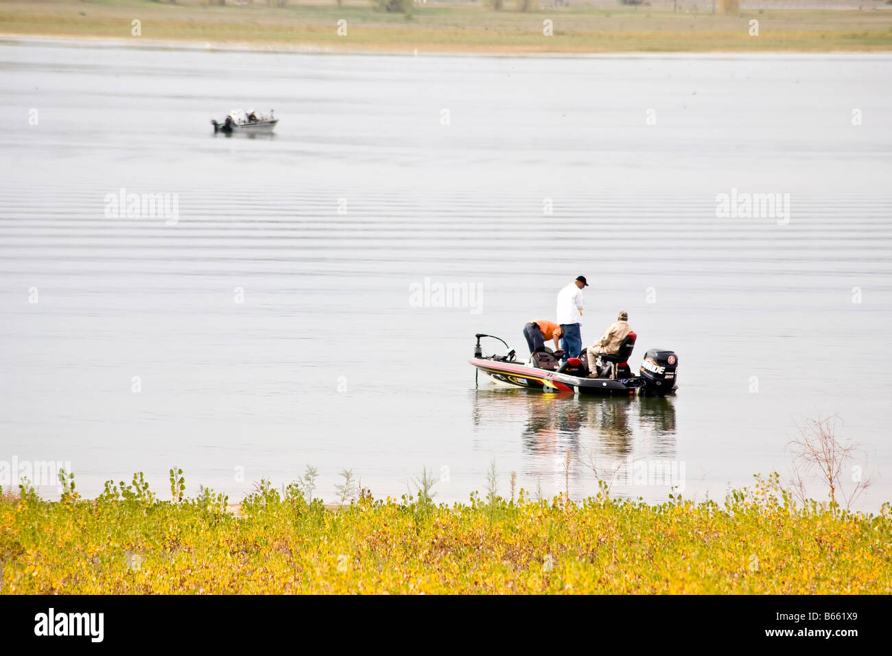Men fishing in a boat on a lake Stock Photo