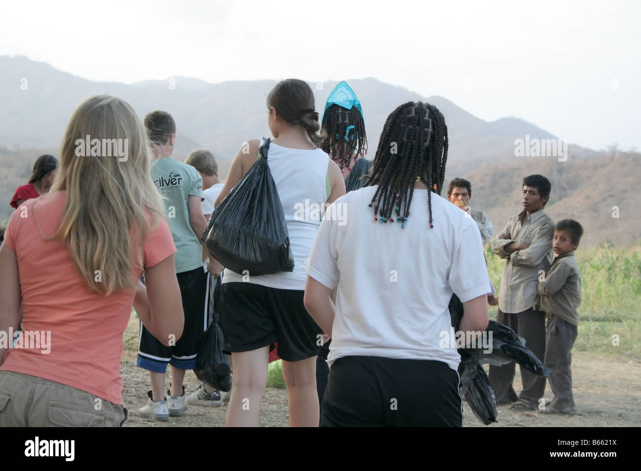 A group of young adult volunteers providing food for poor mexican people Stock Photo