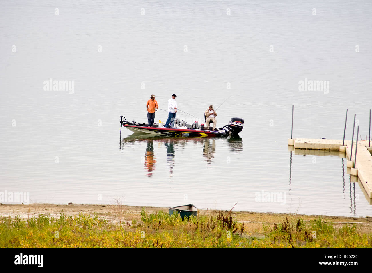 Men fishing in a boat on a lake Stock Photo