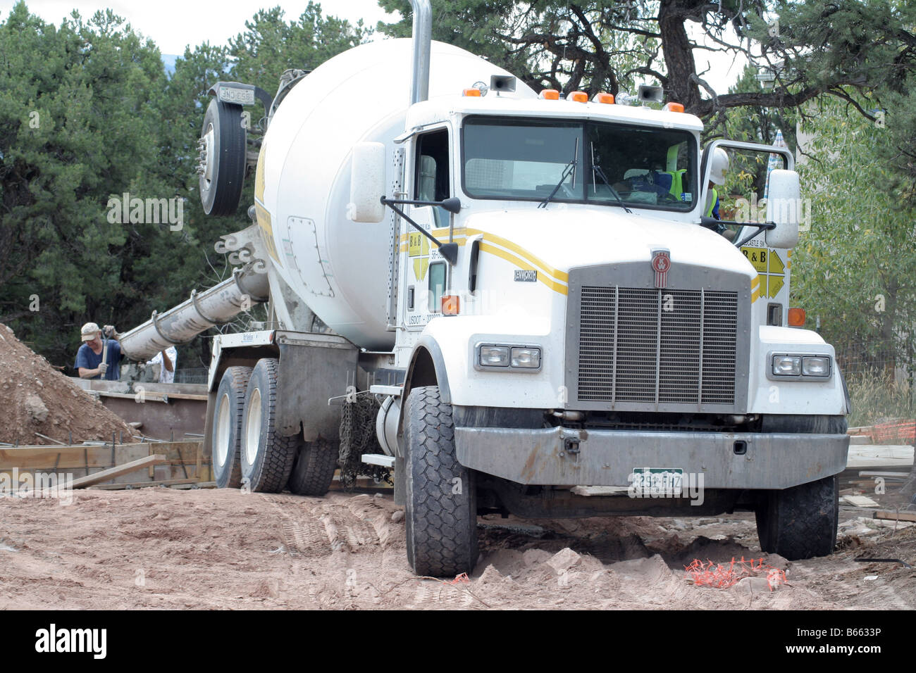 A concrete truck pouring concrete at a house foundation Stock Photo Alamy