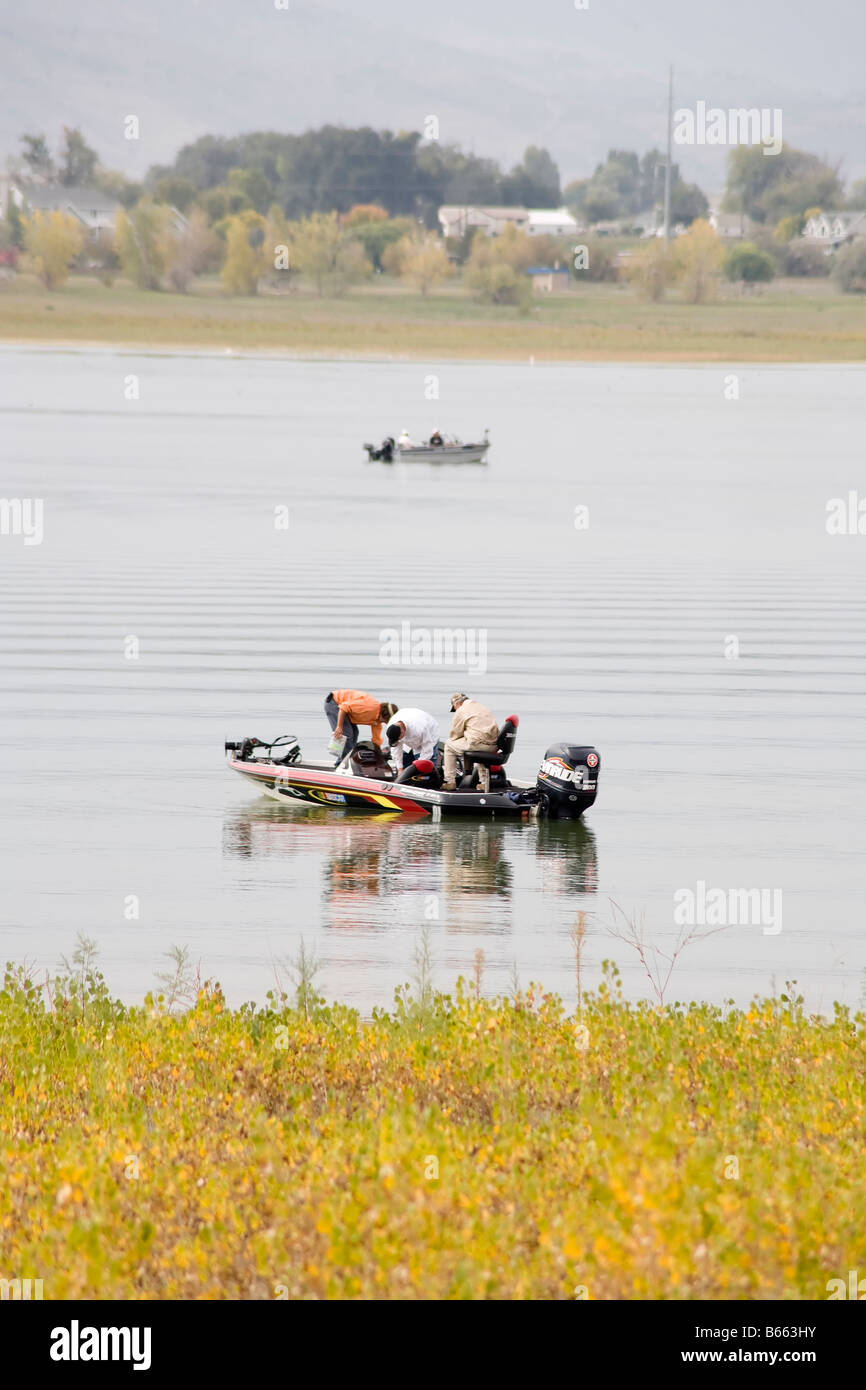 Men fishing in a boat on a lake Stock Photo