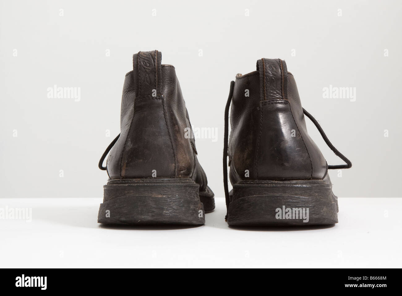 rear of a pair of boots laces untied Stock Photo Alamy