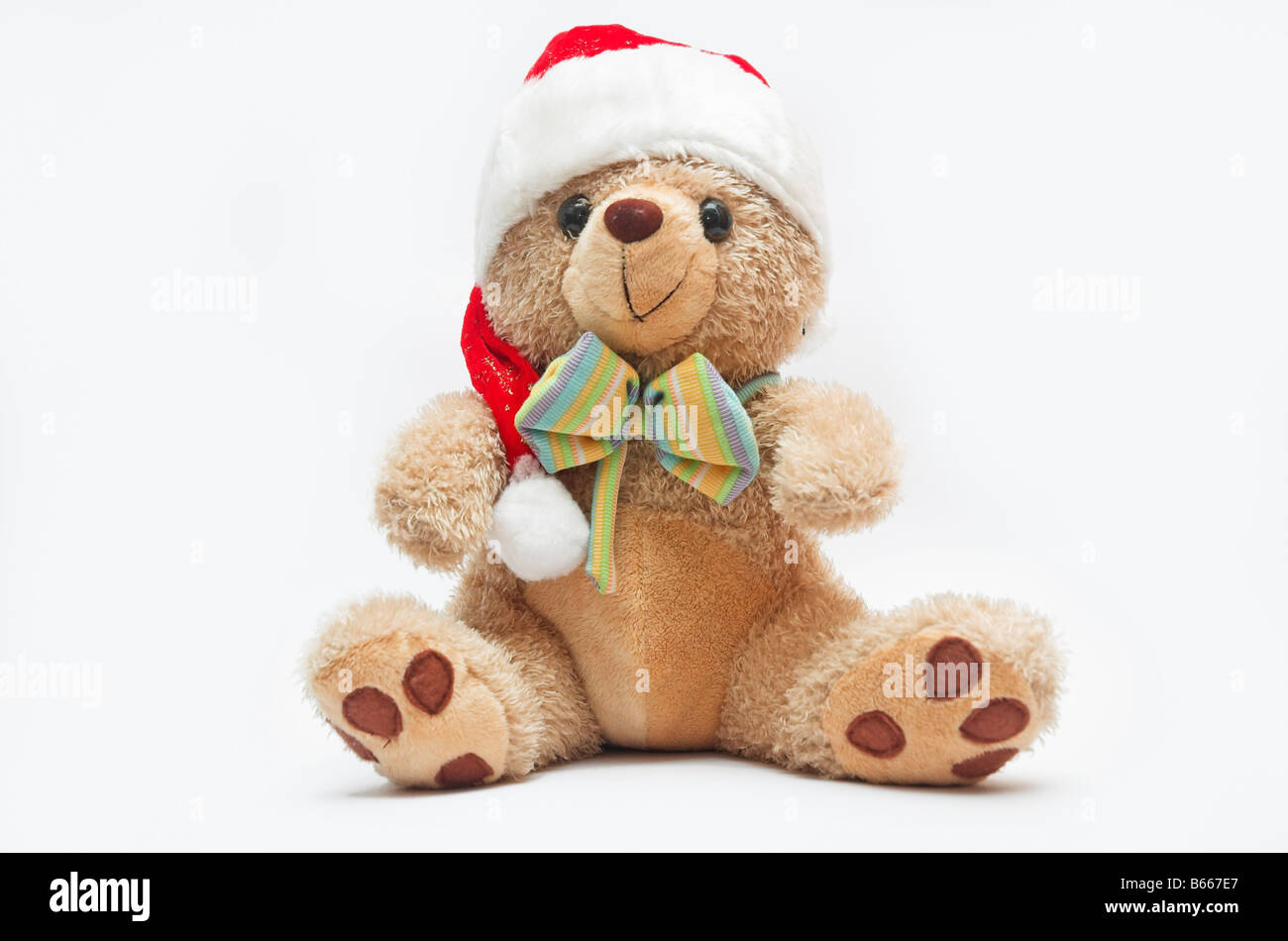 Teddy bear wearing Santa hat isolated on white background Stock Photo ...