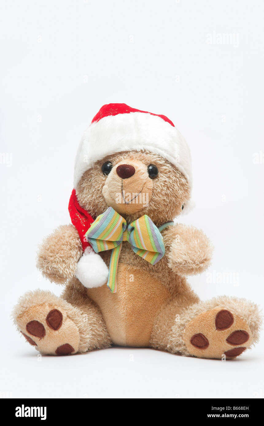 Teddy bear wearing Santa hat isolated on white background Stock Photo