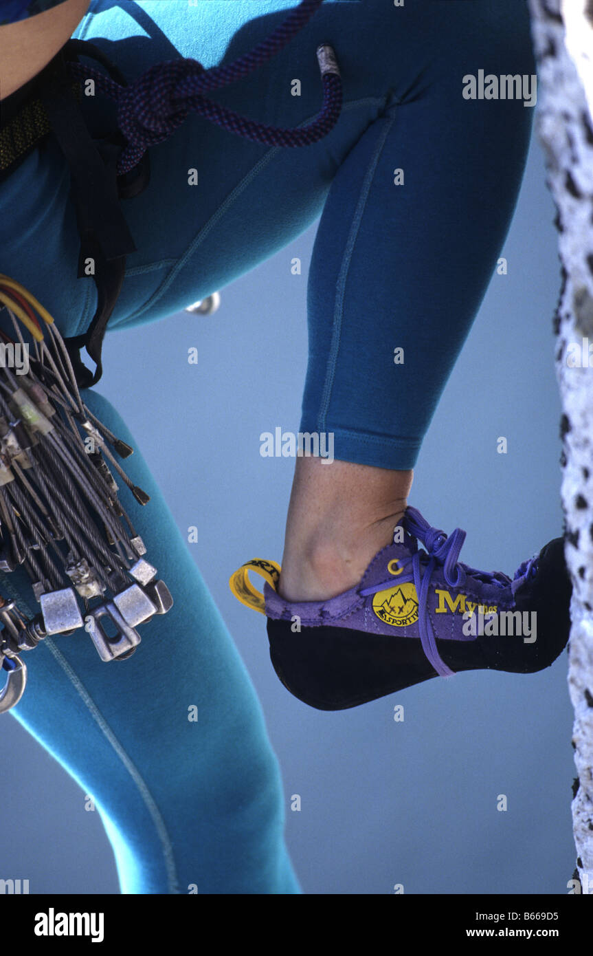 Detail view of woman rock climber's shoe and legs. Stock Photo
