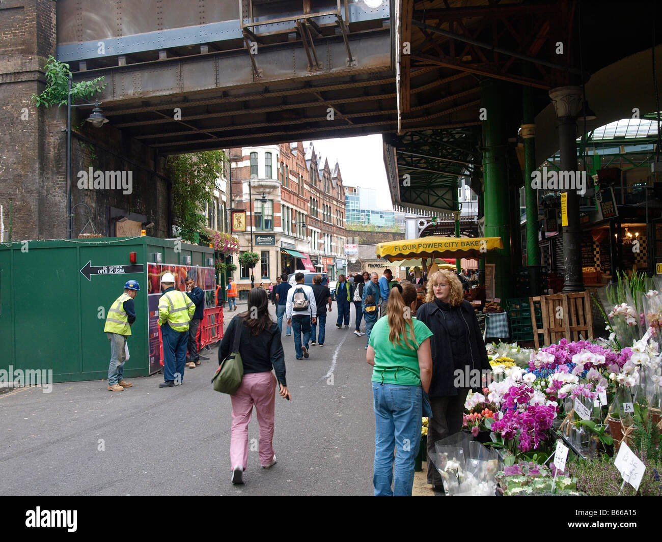 People at flower stand at Borough market London UK Stock Photo