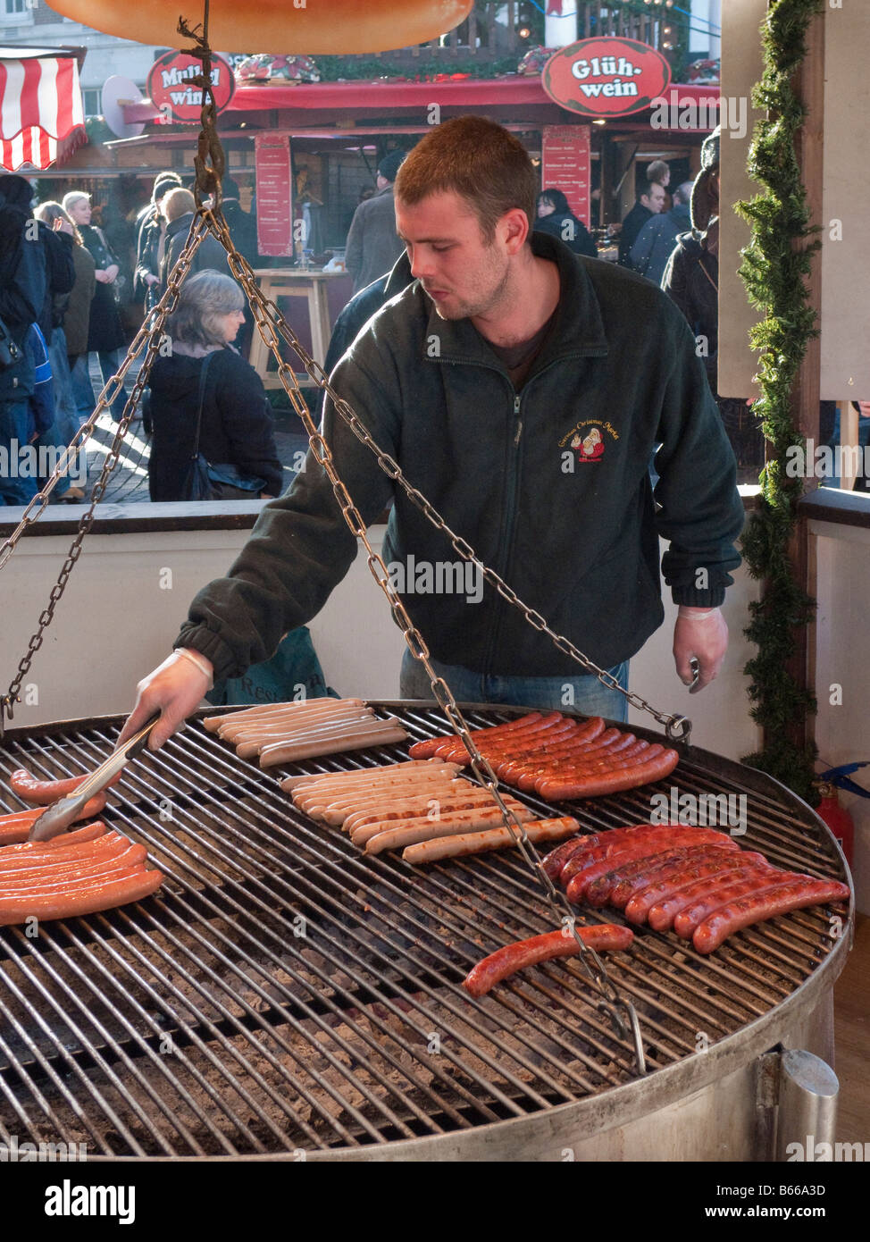 Cooking sausages at the German Christmas market in Kingston upon Thames