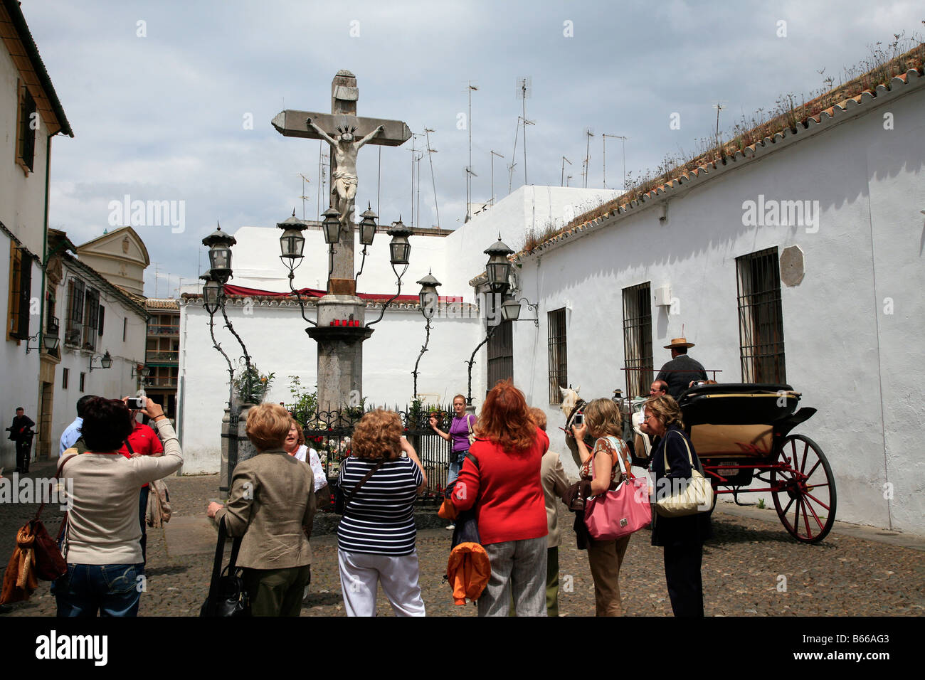Female tourists take photographs of a religious shrine in Cordoba, Spain Stock Photo