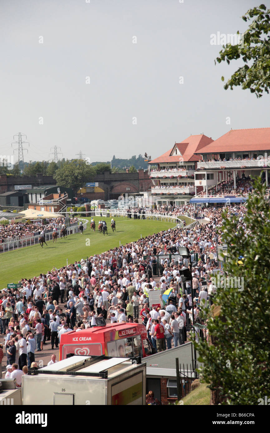 Chester Race course, Race meeting, crowd and horses on course, on a sunny day, Cheshire, England Stock Photo