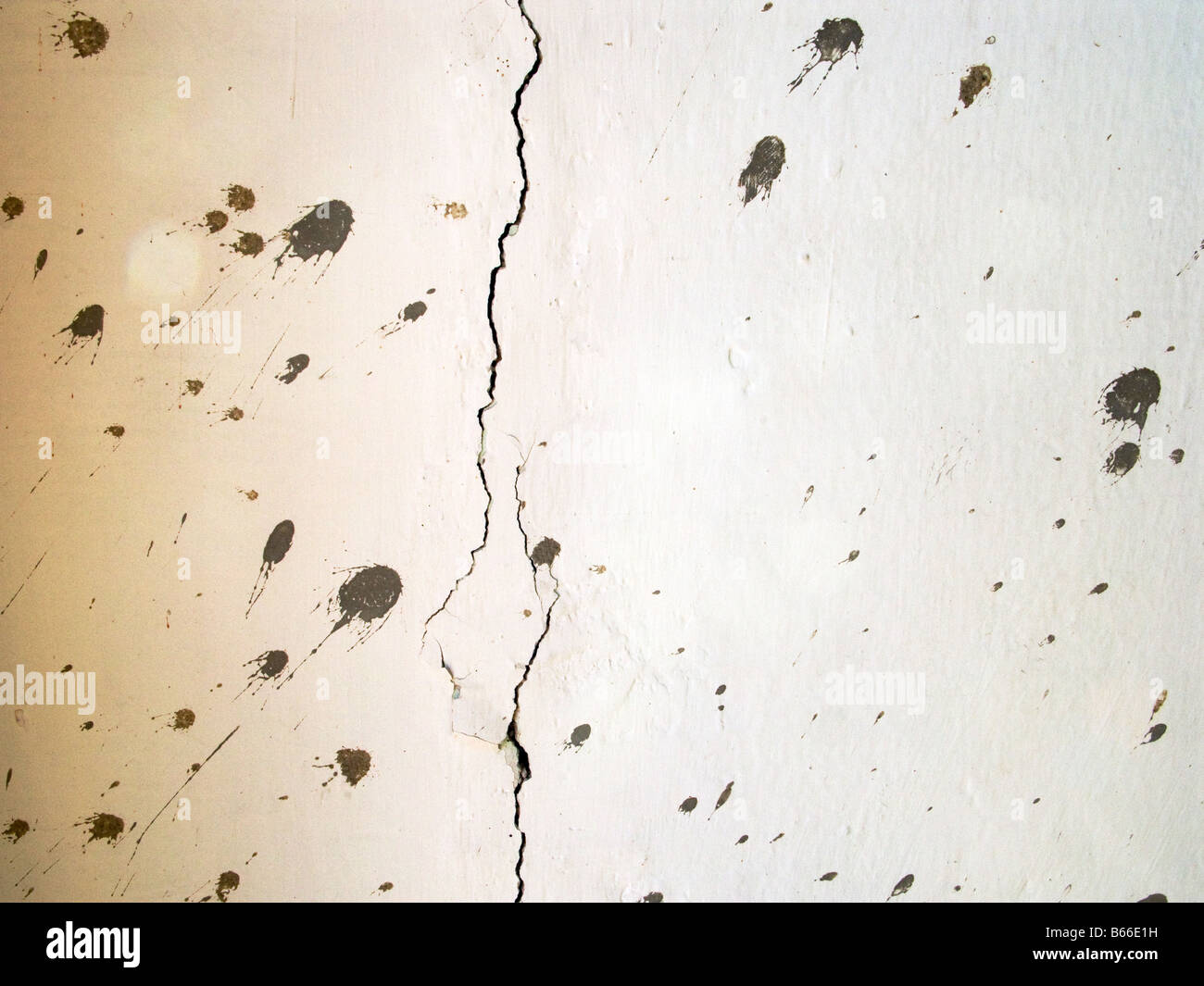 Cracked wall with splattered cement Stock Photo
