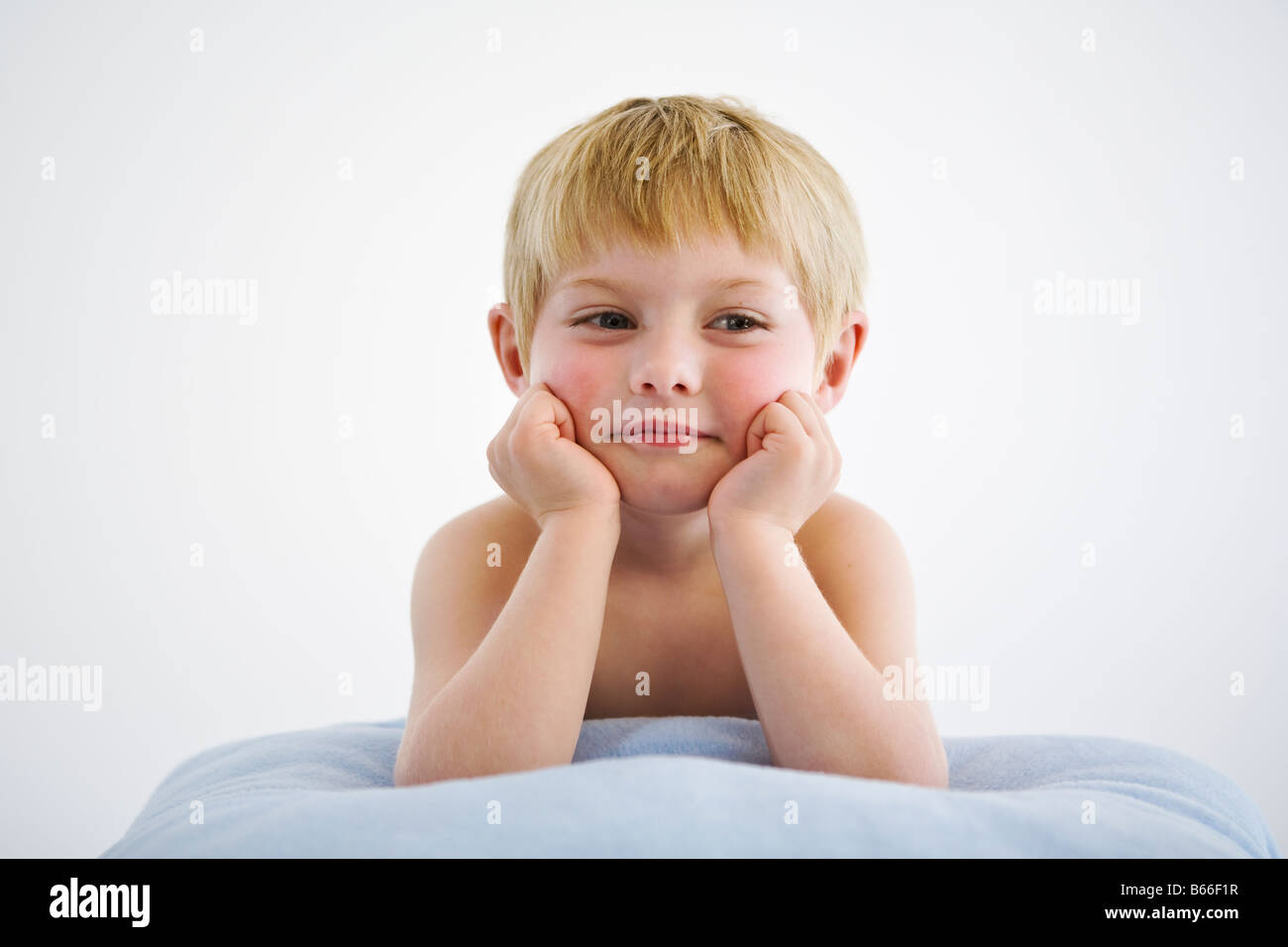 little boy propped on pillow Stock Photo Alamy