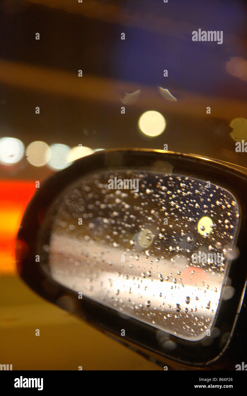 city car rearview mirror with lights and raindrops Stock Photo Alamy