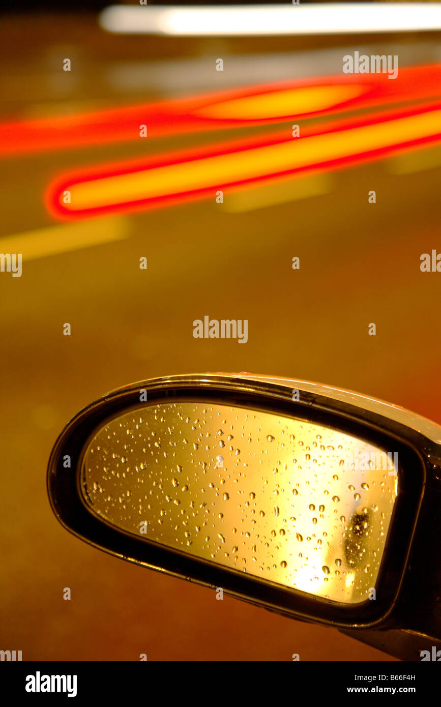 city car rearview mirror with lights and raindrops Stock Photo Alamy