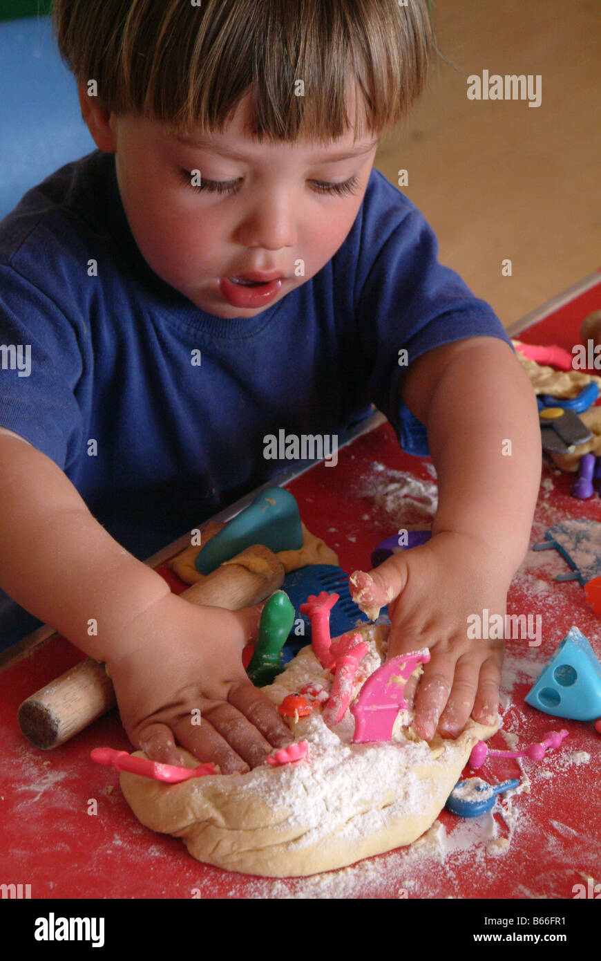Child playing with play dough at nursery Stock Photo - Alamy