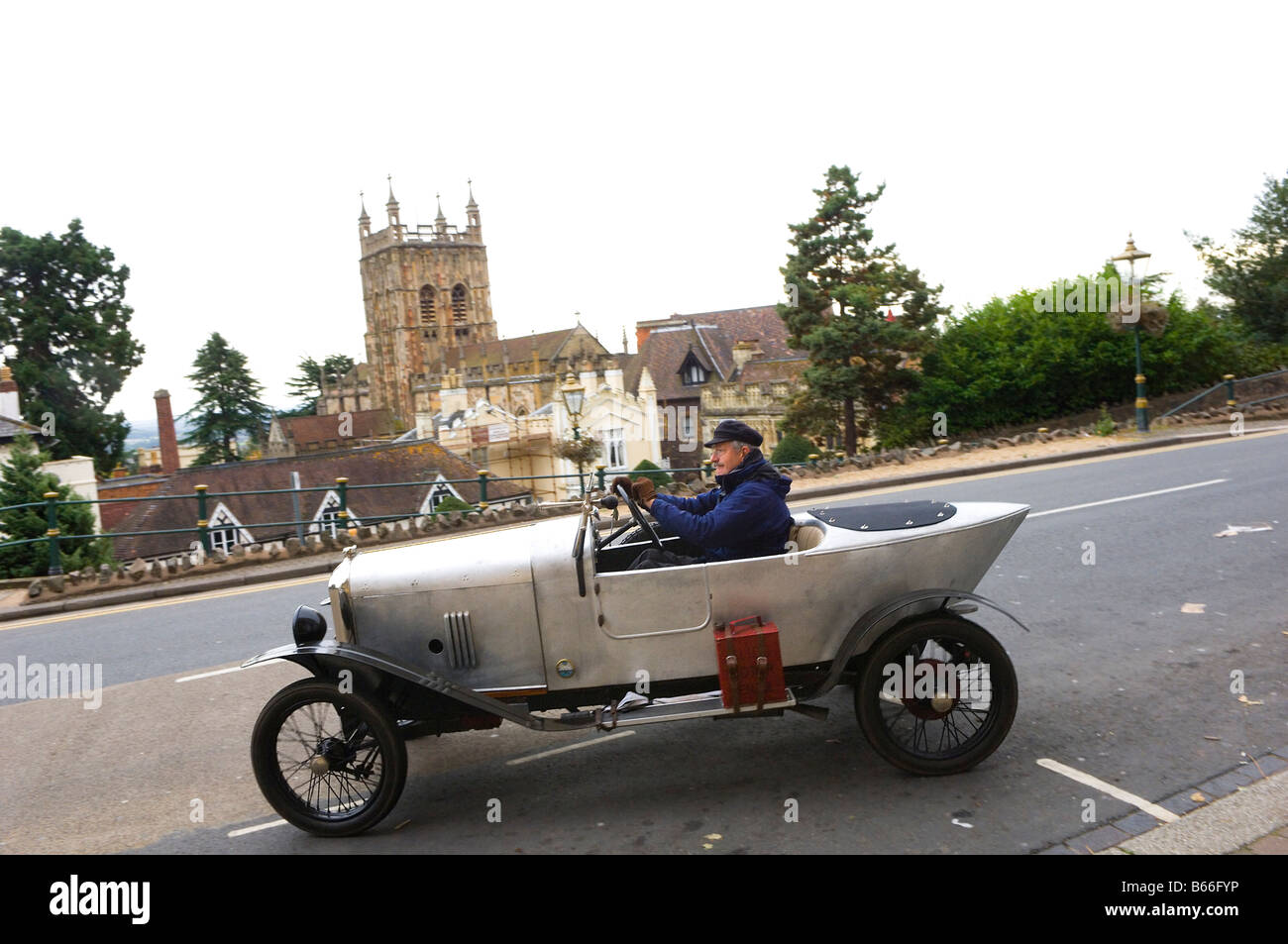 A veteran french Amilcar is seen against the backdrop of The Priory Malvern Worcestershire Great Britain Europe Stock Photo