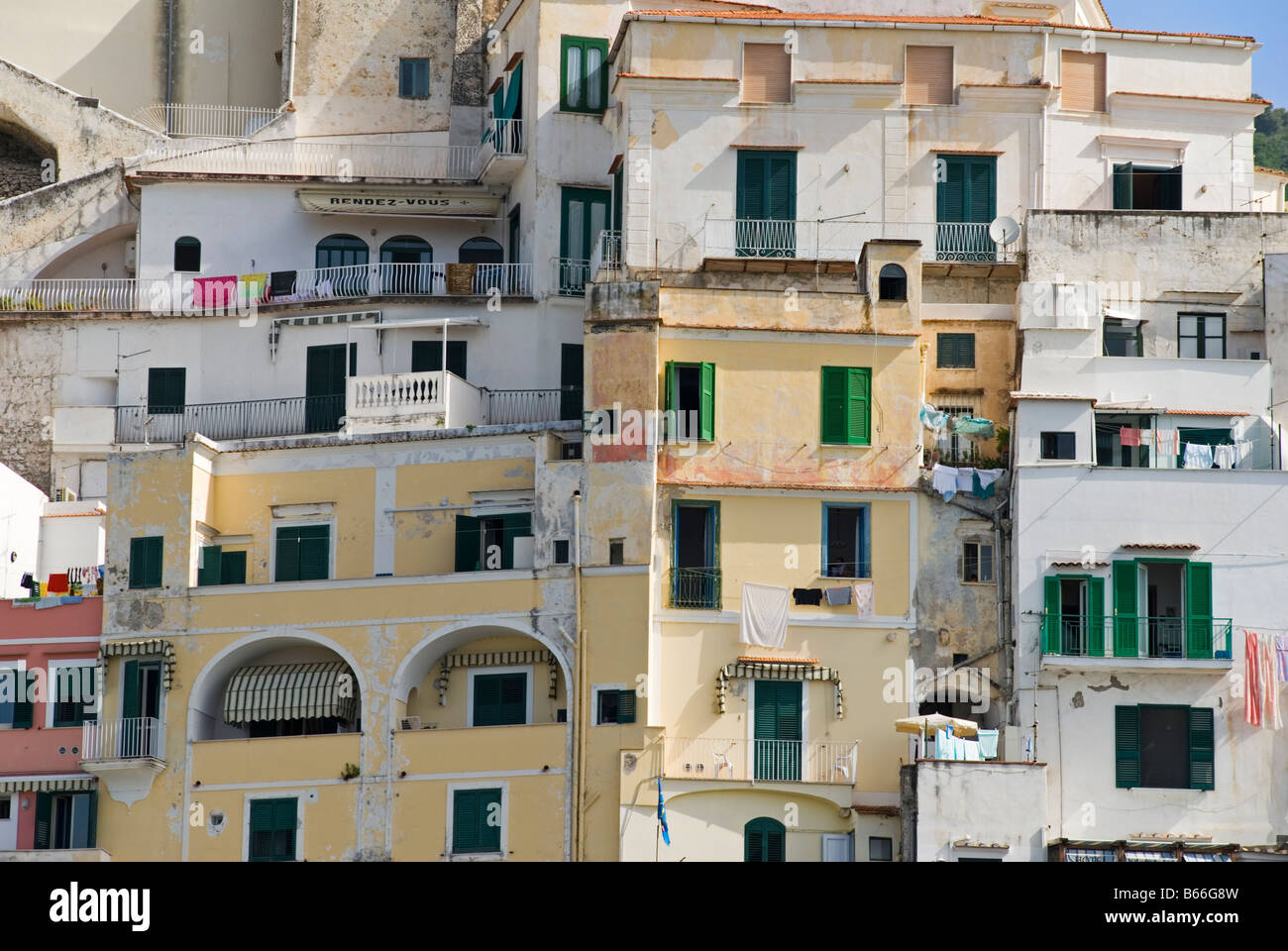 Buildings tower one on top of another, clinging to the steep cliffs that overlook the coast in Amalfi Town, Campania, Italy Stock Photo