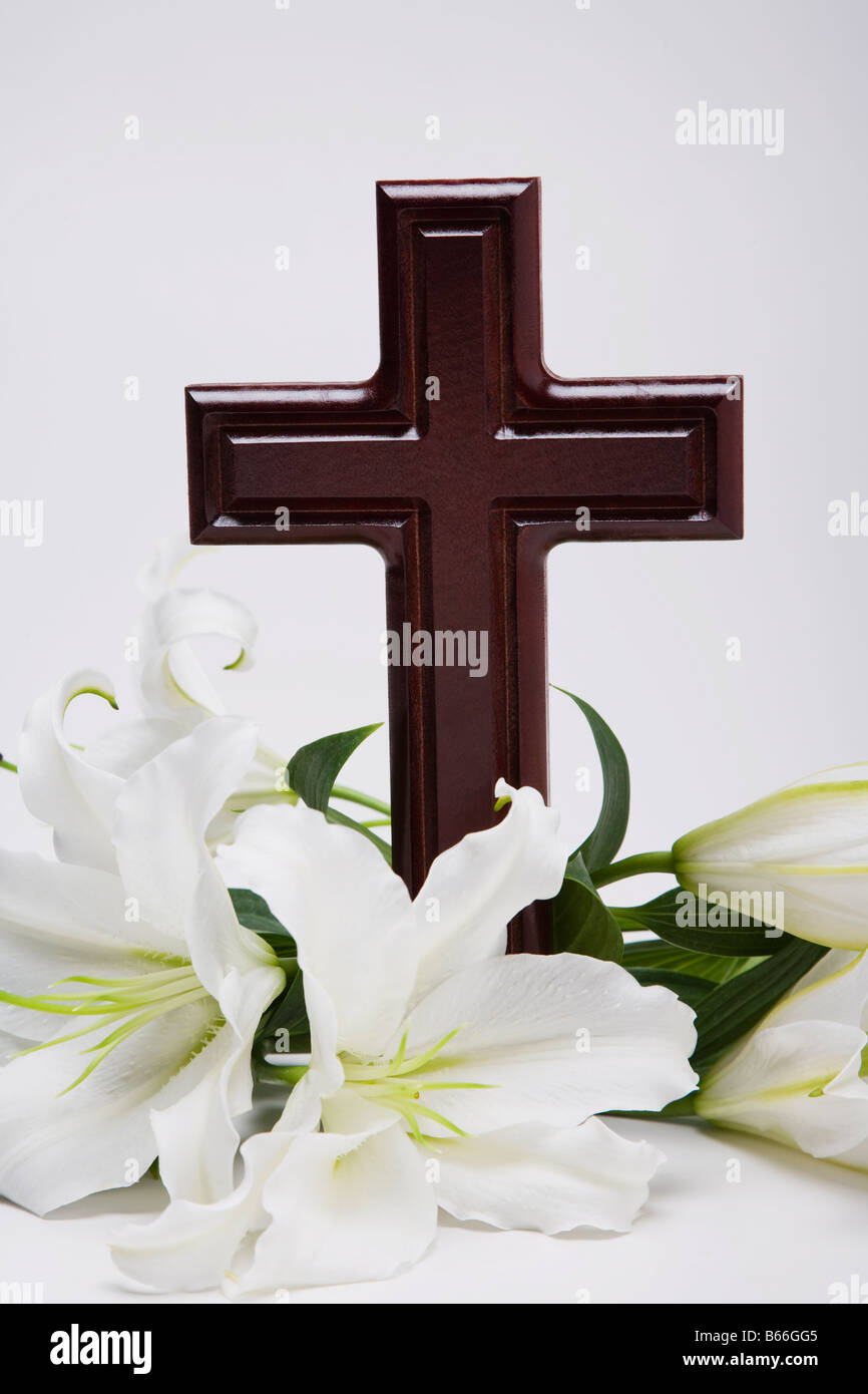 Christian cross with lilies Stock Photo