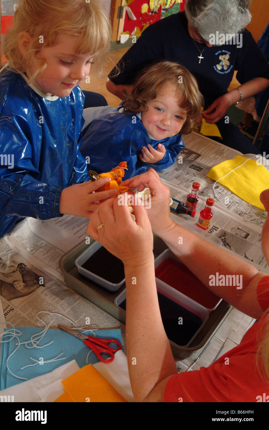 Kids painting together on a large piece of paper Stock Photo - Alamy