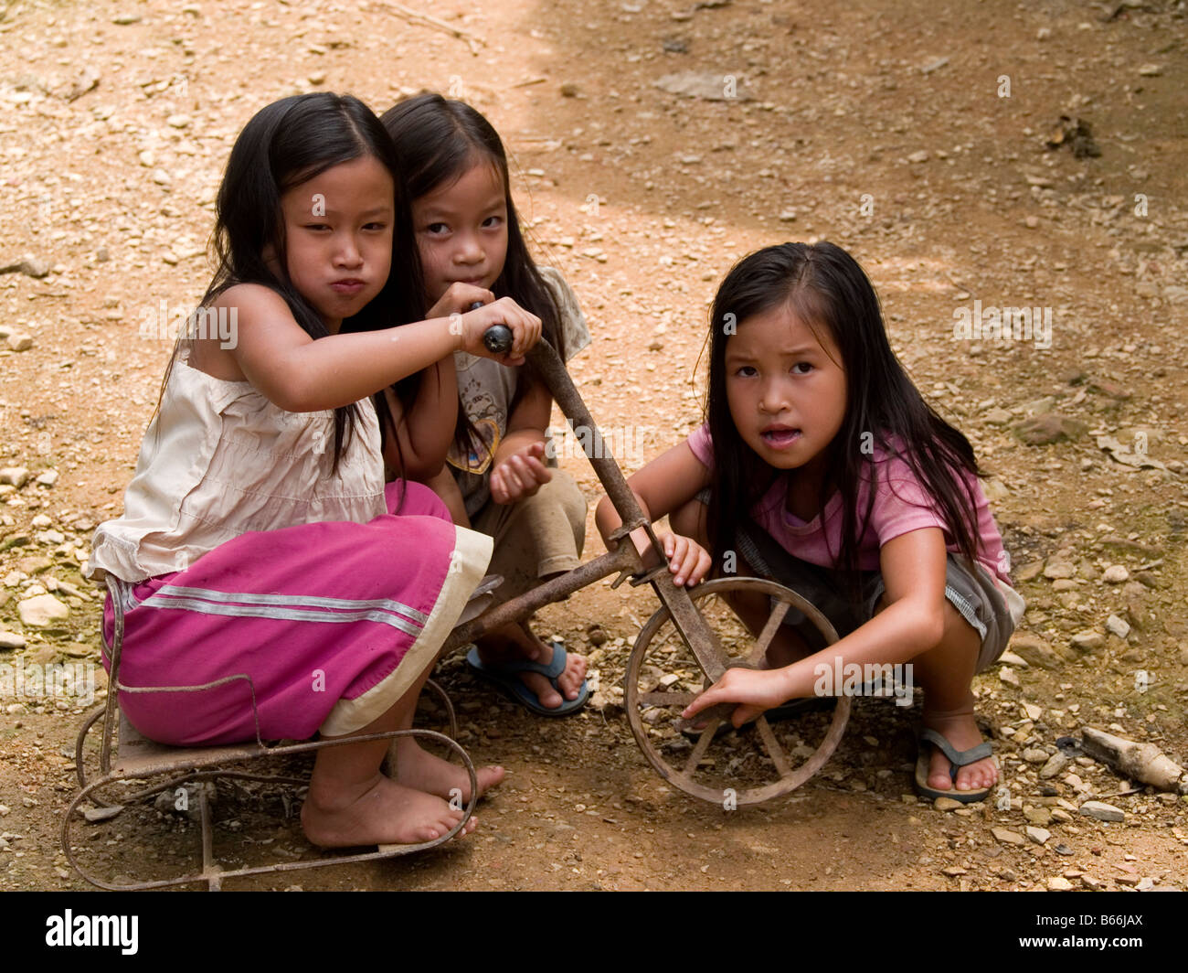 trio of cute girls at play in Muang Ngoi village in northern Laos Stock ...