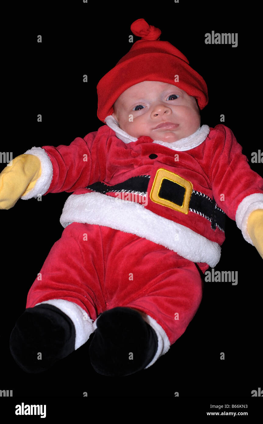 A cut-out of a baby dressed in a holiday Christmas Santa Clause suit. Merry Christmas Happy Holidays Ho Ho Ho! Stock Photo