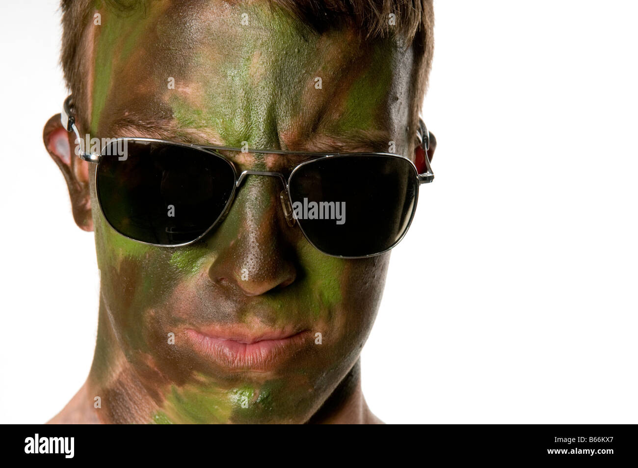 Young man with camouflaged face Stock Photo